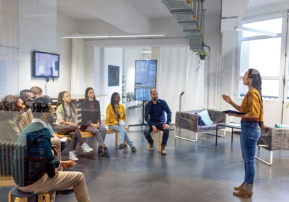 Woman giving presentation to a diverse audience