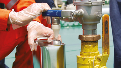 rig worker filling small tank