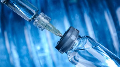 A syringe inserted into a glass vial highlighting the need for studies to identify particulates and foreign particulate matter in injectable drugs