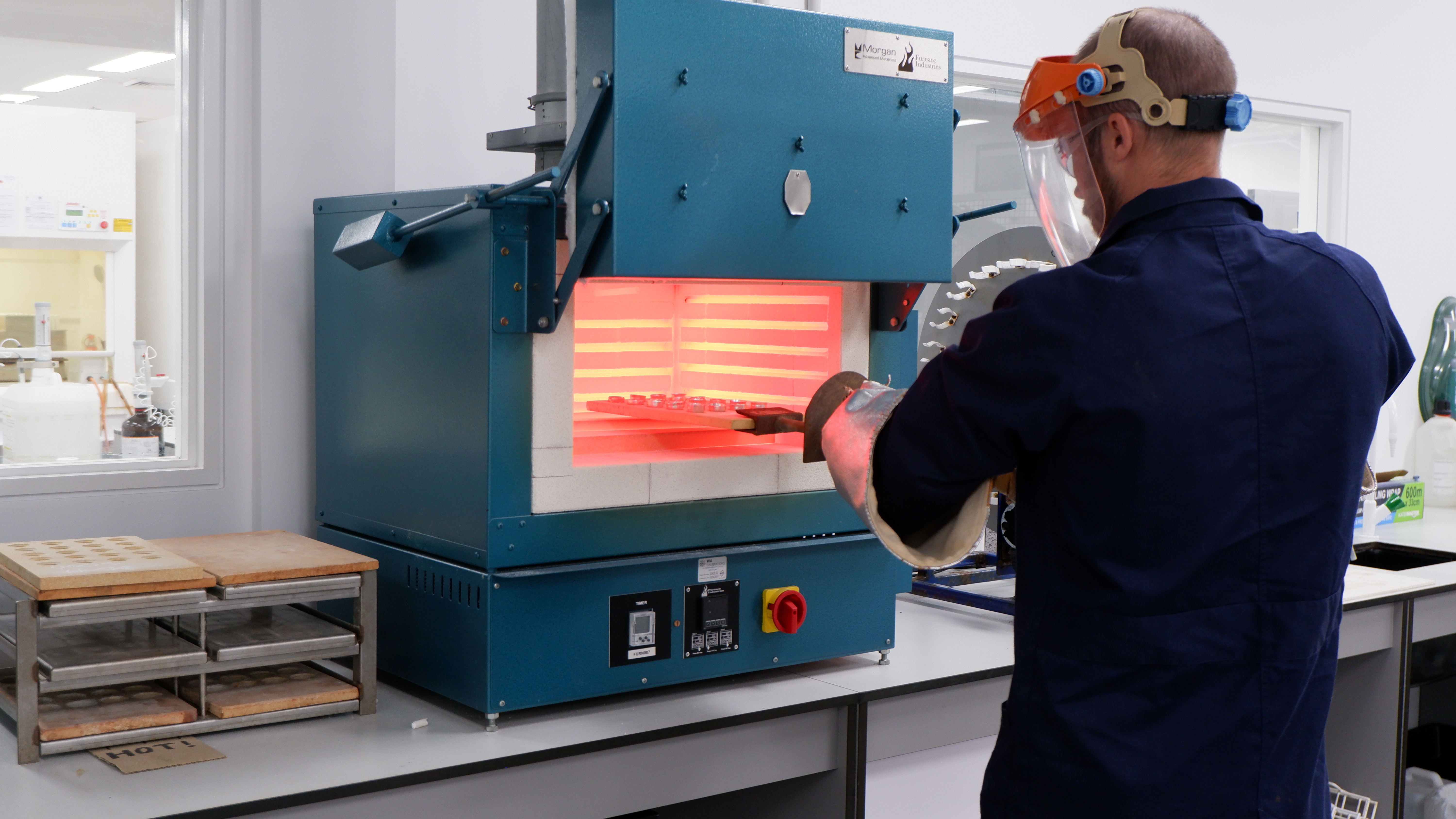 Technician working on the muffle in the lab.